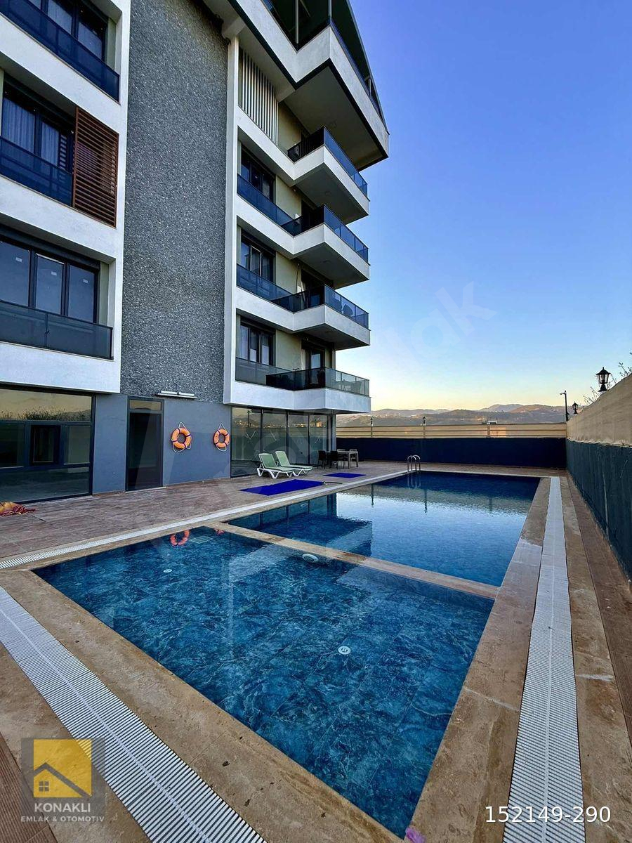 PAYALLAR'DA GENİŞ KULLANIŞLI EŞYALI KAT MÜLKİYETLİ SATILIK 1+1