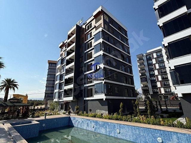 ICONDAN HAVUZLU SİTE İÇERSİNDE GENİŞ OTURUMLU 1+1